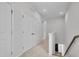 Hallway with carpeted floors, storage closet, and a view of the staircase at 3667 Durwood Ln, Raleigh, NC 27604
