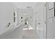 Hallway with natural lighting, linen closet, and carpeted floors at 3667 Durwood Ln, Raleigh, NC 27604