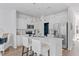 Bright kitchen with white cabinets, stainless steel appliances, kitchen island, and modern pendant lighting at 3667 Durwood Ln, Raleigh, NC 27604