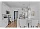 Open concept kitchen with stainless steel appliances, white cabinets, and a kitchen island with barstool seating at 3667 Durwood Ln, Raleigh, NC 27604