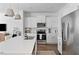 Bright kitchen with white cabinets, stainless steel appliances, and an island with a sink at 3667 Durwood Ln, Raleigh, NC 27604