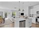 Living room and kitchen with a seamless layout, featuring modern furnishings and a well-lit dining area at 3667 Durwood Ln, Raleigh, NC 27604