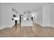 Spacious open-concept living room with hardwood floors, white walls, and views into the kitchen at 3667 Durwood Ln, Raleigh, NC 27604