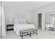 Comfortable main bedroom with a tufted headboard, natural lighting, and a seating bench at 3667 Durwood Ln, Raleigh, NC 27604