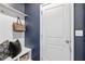 Stylish mudroom with navy walls, a bench with storage, and coat hooks at 3667 Durwood Ln, Raleigh, NC 27604