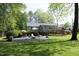 Spacious backyard patio area features outdoor seating, a fire pit, and lush landscaping at 38 Maple Cir, Pittsboro, NC 27312