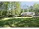 Expansive backyard includes a patio, garden area, and manicured lawn at 38 Maple Cir, Pittsboro, NC 27312