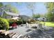 Charming backyard with gravel, outdoor furniture, fire pit, and patio area, perfect for entertaining at 38 Maple Cir, Pittsboro, NC 27312