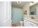 Inviting bathroom featuring a vanity, sink and full bathtub with a light blue shower curtain at 38 Maple Cir, Pittsboro, NC 27312
