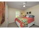 Cheerful bedroom with bright quilt, ceiling fan, and a sunlit window for a cozy retreat at 38 Maple Cir, Pittsboro, NC 27312