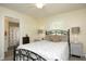 A calm bedroom with a metal frame bed, neutral bedding, and bedside lamps for a serene feel at 38 Maple Cir, Pittsboro, NC 27312
