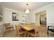 Bright dining room with natural wood table, four chairs, modern lighting, and stylish wall decor at 38 Maple Cir, Pittsboro, NC 27312