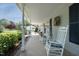 Cozy front porch featuring rocking chairs, decorative wreath, and serene views of the surrounding landscape at 38 Maple Cir, Pittsboro, NC 27312