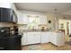 Charming kitchen featuring white cabinets, modern appliances, and natural light from the window above the sink at 38 Maple Cir, Pittsboro, NC 27312