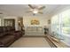 Inviting living room featuring comfortable seating, a ceiling fan, and large windows that let in natural light at 38 Maple Cir, Pittsboro, NC 27312