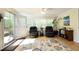 Bright living room with a ceiling fan, plush chairs, and a door to an outdoor deck at 38 Maple Cir, Pittsboro, NC 27312