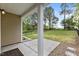 Covered patio overlooking a green, fenced-in backyard with mature trees at 3811 Yates Mill Trail, Raleigh, NC 27606