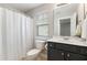 Bathroom featuring a white shower curtain, a dark vanity and silver hardware at 3811 Yates Mill Trail, Raleigh, NC 27606