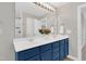 Bathroom boasts double sinks, a large mirror, and shaker-style blue cabinets at 3811 Yates Mill Trail, Raleigh, NC 27606