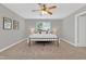 Bright bedroom with a ceiling fan, neutral walls, carpeted floor, and a large rug underneath the bed at 3811 Yates Mill Trail, Raleigh, NC 27606
