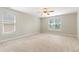 Empty bedroom offers neutral carpet, two windows, and ample space at 3811 Yates Mill Trail, Raleigh, NC 27606