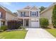Charming two-story home featuring a brick facade, a well-manicured lawn, and an attached garage at 3811 Yates Mill Trail, Raleigh, NC 27606