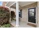 Inviting front porch with a cozy swing, brick accents, and a welcoming black front door at 3811 Yates Mill Trail, Raleigh, NC 27606