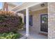 Inviting front porch with brick accents, columns, and a cozy swing for relaxation at 3811 Yates Mill Trail, Raleigh, NC 27606