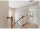 Upstairs hallway with wood railing and open doorway to bedroom at 3811 Yates Mill Trail, Raleigh, NC 27606
