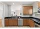 Kitchen featuring stainless steel appliances, dark countertops, and view into the dining area at 3811 Yates Mill Trail, Raleigh, NC 27606