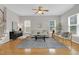 Bright living room with hardwood floors, ceiling fan and comfortable seating arrangement at 3811 Yates Mill Trail, Raleigh, NC 27606