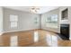 Living room features hardwood floors, a fireplace, and a ceiling fan at 3811 Yates Mill Trail, Raleigh, NC 27606