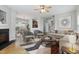 Bright living room featuring neutral decor, hardwood floors, fireplace, and open layout to the kitchen at 3811 Yates Mill Trail, Raleigh, NC 27606