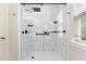 Modern walk-in shower with white subway tile and sleek black hardware at 3811 Yates Mill Trail, Raleigh, NC 27606
