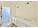Light-filled bathroom features a double sink vanity and updated lighting at 3817 Coach Lantern Ave, Wake Forest, NC 27587