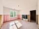 Bedroom under construction featuring insulation, a window with natural light, and a doorway to a potential ensuite bathroom at 3817 Coach Lantern Ave, Wake Forest, NC 27587