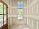 Bright entry way featuring light-filled windows and a wooden door ready to welcome you home at 3817 Coach Lantern Ave, Wake Forest, NC 27587
