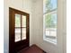 Bright entryway featuring a wood door with glass panels and natural light from a nearby window at 3817 Coach Lantern Ave, Wake Forest, NC 27587