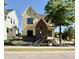 Two-story home with yellow siding, dark brick accents, modern black windows, and professional landscaping at 3817 Coach Lantern Ave, Wake Forest, NC 27587