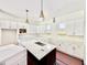 Bright kitchen featuring a center island with marble countertops, white cabinets, and modern pendant lighting at 3817 Coach Lantern Ave, Wake Forest, NC 27587