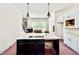 Kitchen featuring a large island with a sink, pendant lights, and views of the living room and staircase at 3817 Coach Lantern Ave, Wake Forest, NC 27587