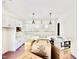 Kitchen featuring white cabinetry and marble countertops with an island and pendant lighting at 3817 Coach Lantern Ave, Wake Forest, NC 27587