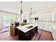 New kitchen with an island, marble countertops, stainless sink, white cabinets, and pendant lighting at 3817 Coach Lantern Ave, Wake Forest, NC 27587