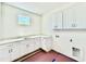 This laundry room includes storage cabinets and a countertop sink at 3817 Coach Lantern Ave, Wake Forest, NC 27587