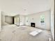 Open living room with fireplace, large windows, and sliding glass doors leading to an outdoor area at 3817 Coach Lantern Ave, Wake Forest, NC 27587