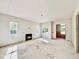 Bright living room with fireplace, windows, and doorway leading to another room with exposed insulation at 3817 Coach Lantern Ave, Wake Forest, NC 27587