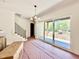 Bright living room with staircase and large sliding glass doors leading to an outdoor space at 3817 Coach Lantern Ave, Wake Forest, NC 27587