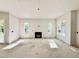 Spacious living room featuring a fireplace and ample natural light from large windows at 3817 Coach Lantern Ave, Wake Forest, NC 27587