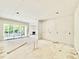 Open-concept living space with sliding glass doors, a fireplace, and ample natural light at 3817 Coach Lantern Ave, Wake Forest, NC 27587
