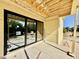 New construction patio with large black frame sliding glass doors and a bright view of the landscape at 3817 Coach Lantern Ave, Wake Forest, NC 27587